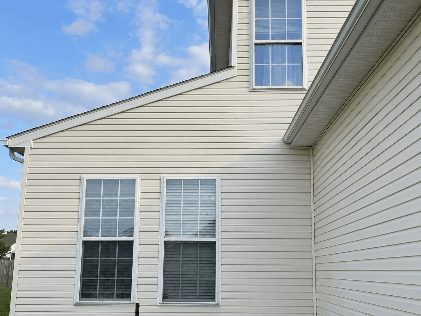 After: a Central New York home, dirty siding on one side and freshly soft-washed on the other
