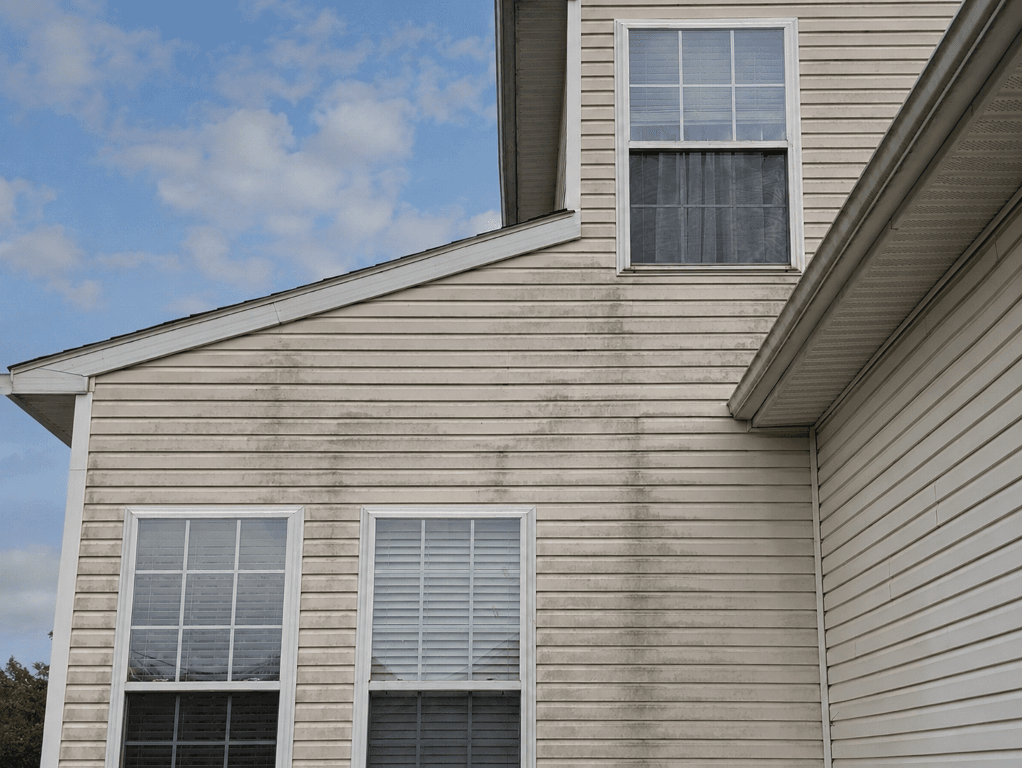 Before: a Central New York home, dirty siding on one side and freshly soft-washed on the other